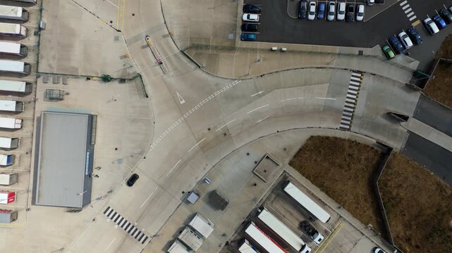 Top down aerial view of parked cars and HGV lorries lined up at logistics distribution centre Luton UK