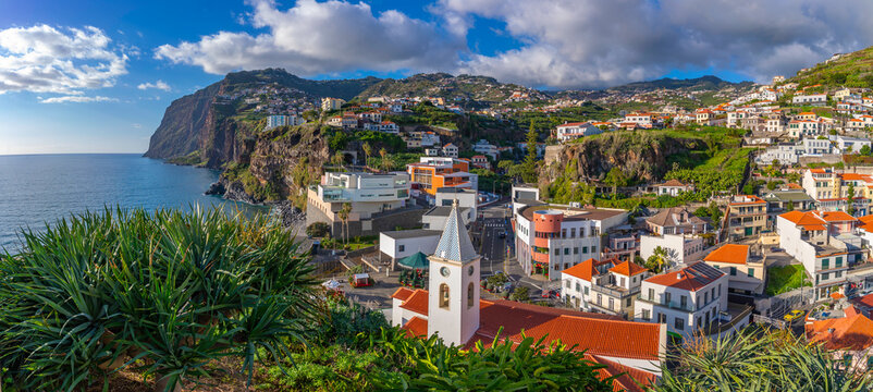 Elevated view of Igreja Matriz de Sao Sebastiao church and Camara de Lobos on a sunny day, Funchal, Madeira, Portugal