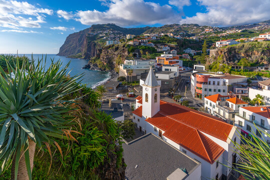 Elevated view of Igreja Matriz de Sao Sebastiao church and Camara de Lobos on a sunny day, Funchal, Madeira, Portugal
