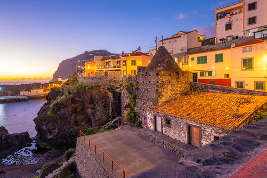 View of colourful houses in Camara de Lobos at dusk, Funchal, Madeira, Portugal