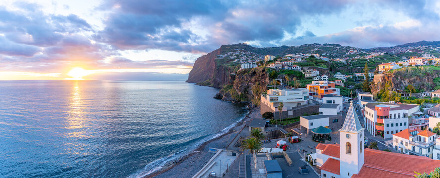 Elevated view of Igreja Matriz de Sao Sebastiao church and Camara de Lobos at sunset, Funchal, Madeira, Portugal