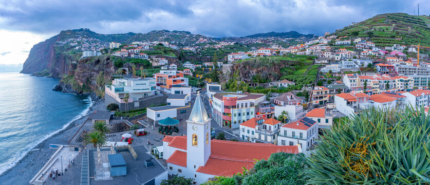 Elevated view of Igreja Matriz de Sao Sebastiao church and Camara de Lobos at sunset, Funchal, Madeira, Portugal