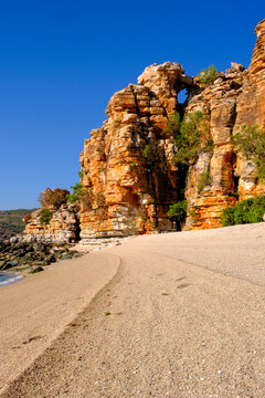 Rock formations with a clean beach and clear blue sky near the coast of Kimberley