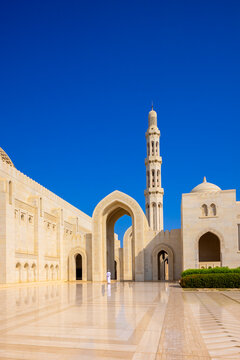 Muslim worshipper stands at Sultan Qaboos Grand Mosque during midday in Muscat, Oman