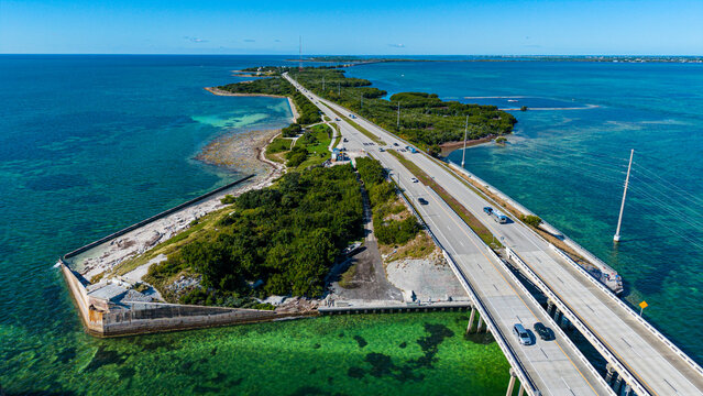 View of Highway Number 1 crossing over water and land in Florida Keys with vehicles traveling along the route