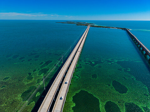 View of Highway Number 1 with clear waters and green aquatic vegetation in Florida Keys, connecting the islands in the distance