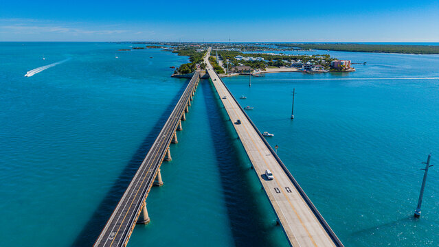 View of 7 mile bridge over turquoise waters with vehicles traveling along the highway in the Florida Keys