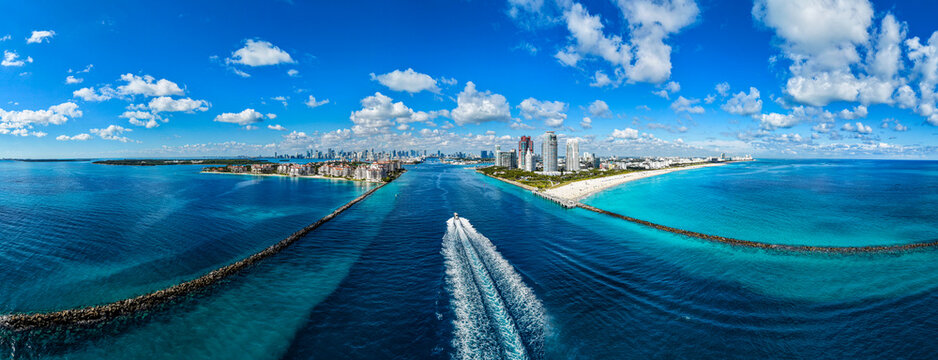 Vibrant view of coastal waterways and city skyline in Florida during daytime with boats moving through the water