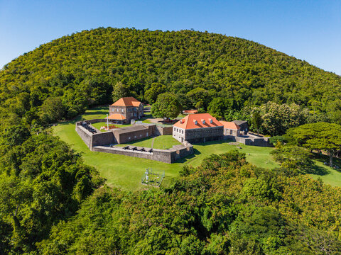 Fort Shirley built in the 18th century sits on a hillside surrounded by greenery in the Caribbean