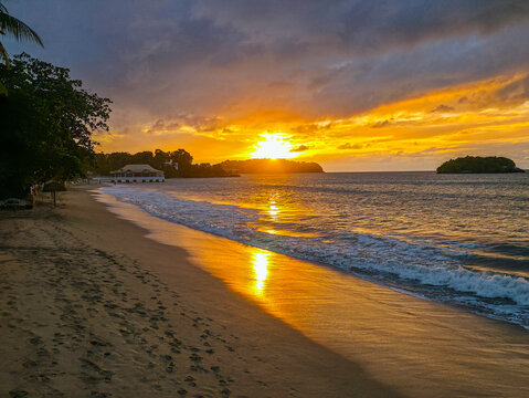 Sunset over La Toc beach with waves and sandy shore in Saint Lucia
