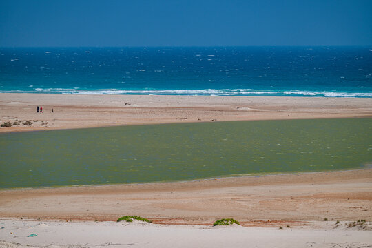 View of Eyl lagoon and beach with blue sea in the background with people on the shore in Puntland Somalia