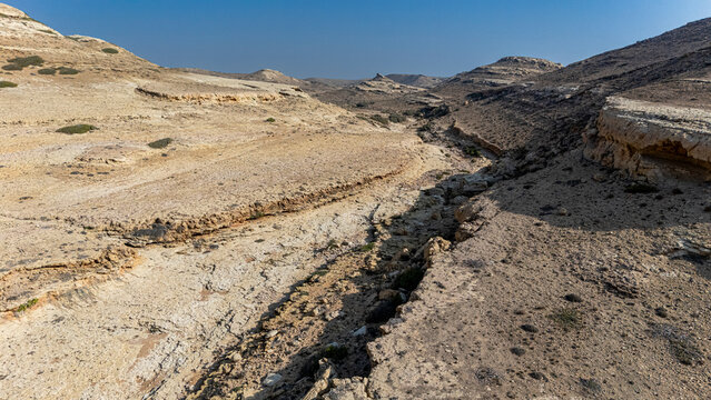 Canyon landscape filled with dry terrain and rock formations near a dry riverbed in Puntland