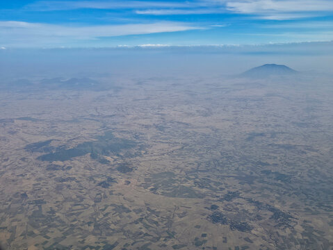Volcanos rise above the landscape in the rift valley near Ethiopia in an aerial view