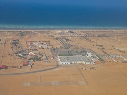 View of urban development along the coastline near a desert area with proximity to water in Puntland, Somalia