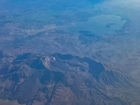 Aerial view of volcanos forming the rift valley landscape in Ethiopia with a lake in the background