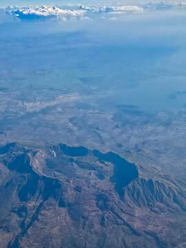 Aerial view of volcanic formations and landscape features in a rift valley region during a clear day in Ethiopia