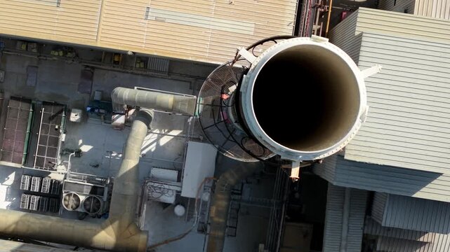 Close Up Aerial View of Industrial Chimney Smoke Stack with Heat Haze and Emissions in Harlow UK