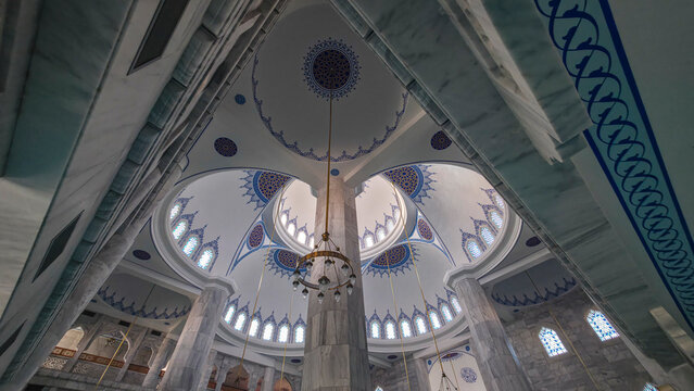 Detailed view of the interior architecture and design elements of Ali Jimale Mosque with decorative patterns and lighting