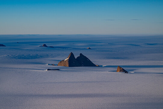 Mountain tops peeking out of the glaciers of Queen Maud Land, Antarctica