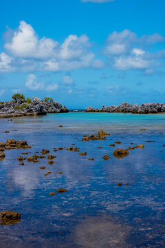 Vertical view of shallow lagoon with coral remnants over reef flat on Rangiroa Atoll in French Polynesia