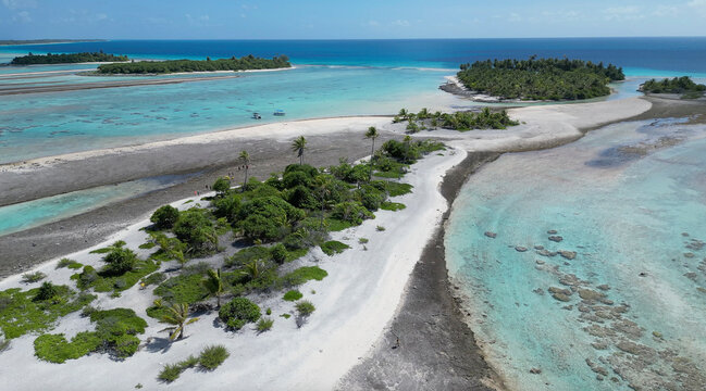 White sand peninsula surrounded by clear water in French Polynesia offers a scenic view of nature and tranquility