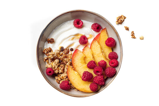Granola bowl with yogurt, peach, raspberry and honey