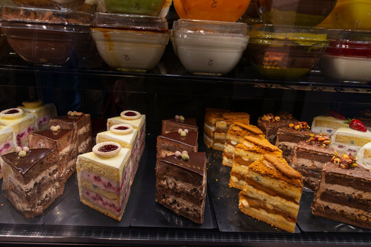 Delicious cakes lined up in a confectioners window in Istanbul, featuring various flavors and designs