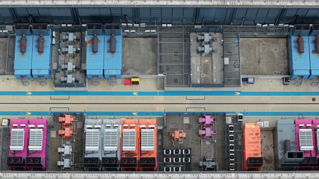 Close Up Aerial View of Industrial Data Center Cooling Units and Backup Power Generators in the UK