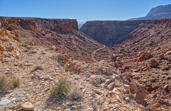 Unmaintained trail leading to Soap Creek Mesa with rocky terrain and steep cliffs in Vermilion Cliffs National Monument