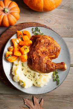 Autumn meal: roasted chicken quarter with pumpkin and mashed potato