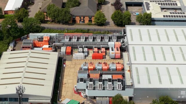 Aerial view of data center roof chiller units and industrial cooling fan banks in the UK
