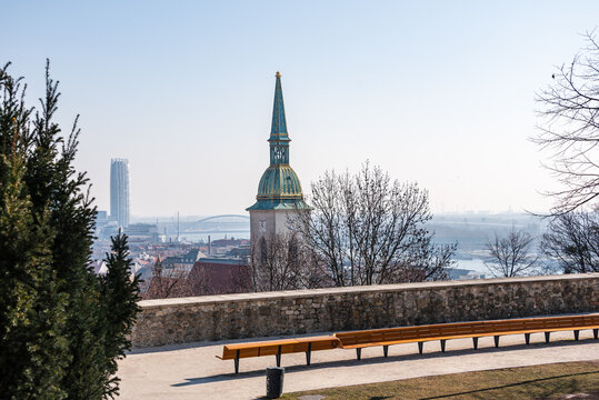 View from park bench near St Martins Cathedral with modern skyline and Danube in background in Bratislava, Slovakia