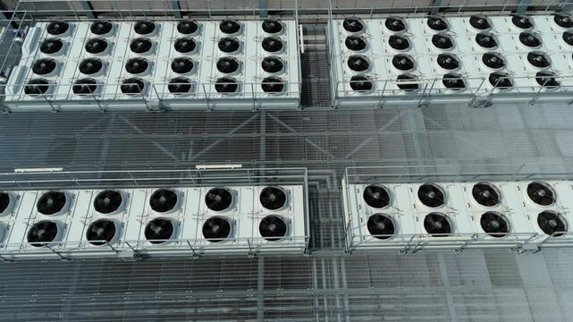 Close Up Aerial View of Large Rooftop HVAC Cooling Fans and Ventilation Systems on Modern Data Center