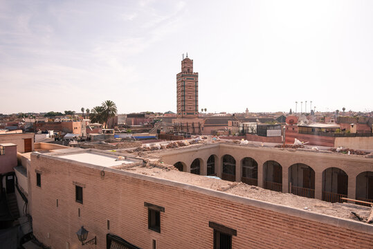 Koutoubia Mosque above rooftops viewed from a traditional riad terrace in Marrakech during the day