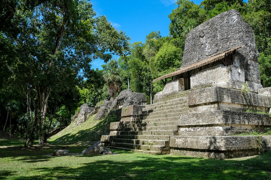 Wide view of the ceremonial structures in the Plaza of the Seven Temples at Tikal during the Classic period in Guatemala