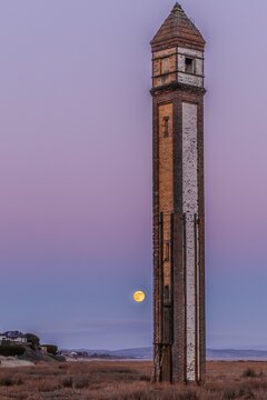 Wolf moon rising behind Rampside Needle on Cumbrian Coast near Barrow-in-Furness at dusk