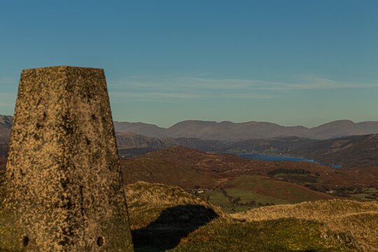 View of distant hills and a lake from Kirkby Moor in South Cumbria under clear skies