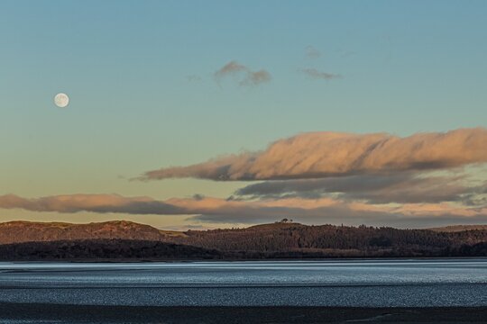 Wolf moon appears in the sky above Morecambe Bay during evening