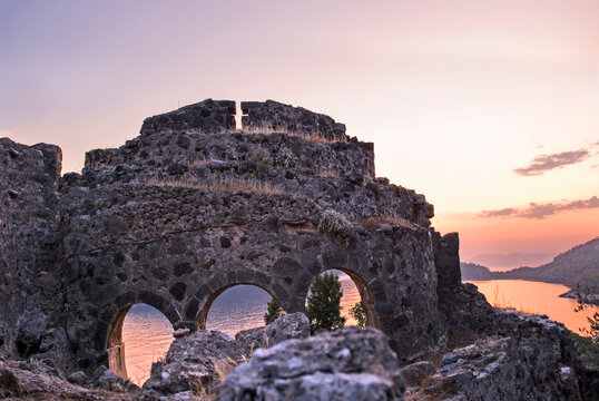 Remains of Byzantine chapel on Gemiler island under sunset sky near Fethiye Turkey