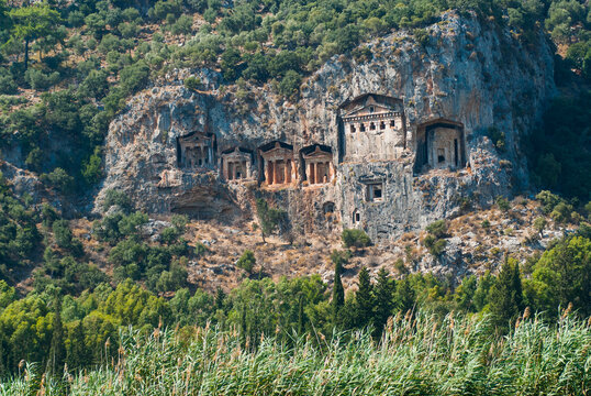 Rock-cut Lycian tombs carved into the cliffs above the river channel in Turkey