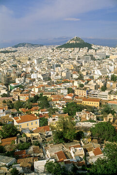 View of Athens from Acropolis with Mont Lycabettus in the background overlooking cityscape and rooftops in the Attica region of Greece