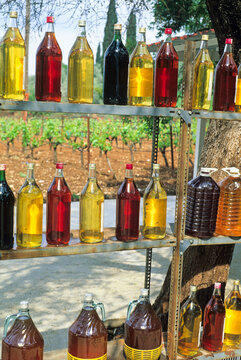 Bottles of wine lined up for sale along the roadside near vineyards in southern Greece