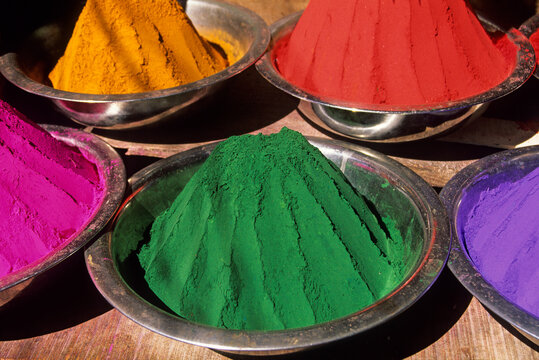 Bright colors of tilaka powder in bowls at Devaraja market with various shades reflecting local culture and tradition in Mysore