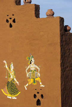 Artistic wall mural depicting traditional Indian figures in Shilpgram Village near Udaipur showing cultural heritage and craftsmanship