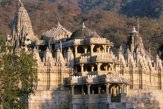 Intricate design of Jain temple at Ranakpur dedicated to Adinatha displays stone carvings and architecture in clear daylight