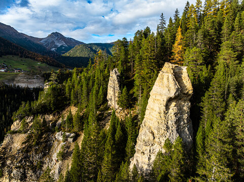 Earth Pyramids of Wiesen among forest trees, Davos, Graubunden, Switzerland