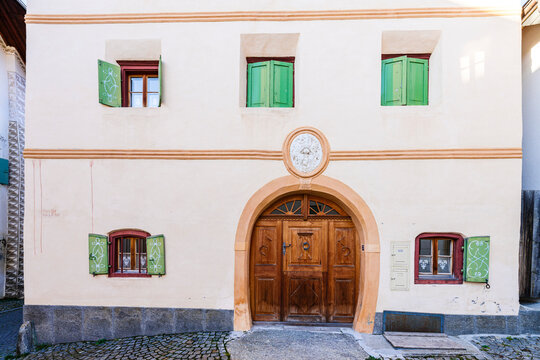 Old facade with green shutters and doorway, Guarda, Engadin, Graubunden, Switzerland