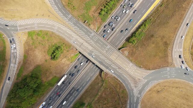 Aerial Hyperlapse of Heavy Traffic Flowing Through Busy Motorway Junction and Roundabout Interchange