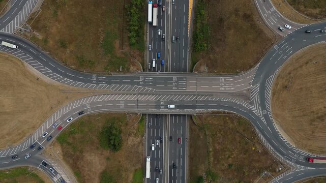 Aerial Hyperlapse of Heavy Traffic Flowing Through Busy Motorway Junction and Roundabout Interchange