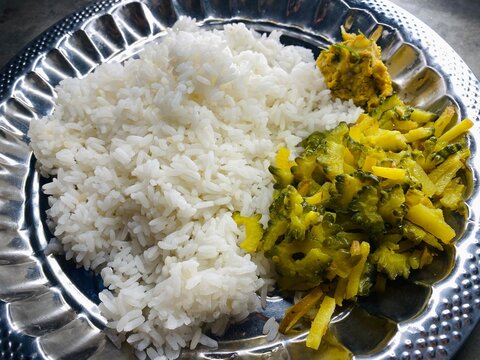Traditional Bengali Rice Meal with Bitter Gourd Stir Fry and Mustard Mash
